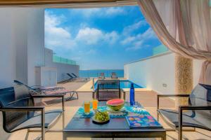 a dining room with a table and a view of the ocean at Villa Claraboya Sea View by Villa Plus in Torrox Costa