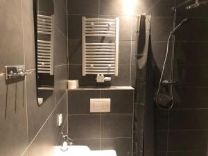 a bathroom with a sink and a shower with a mirror at Hotel Adam in Berlin