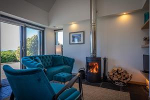 a living room with two chairs and a fireplace at The Byre in Stein