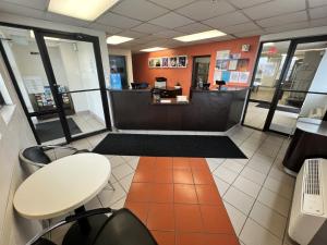 a waiting room with a counter in a store at Motel 6-Council Bluffs, IA - Omaha East in Council Bluffs +16 photos