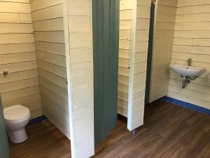 a bathroom with a toilet and a sink at The Kestrel Shepherd Hut, Whitehouse Farm in Stowmarket