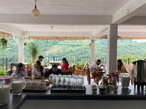 a group of people sitting at a table in a restaurant at K&M HOTEL in Xilitla