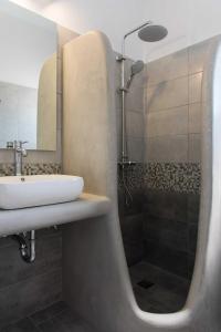 a bathroom with a sink and a shower at Thalassea Sifnos apartments in Platis Yialos Sifnos +39 photos
