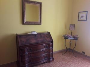 a dresser in a room with a mirror and a table at Casa Verde in Monticchio +17 photos