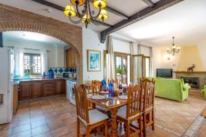 een keuken en eetkamer met een tafel en stoelen bij Villa Tres Olivos by Villa Plus in Frigiliana