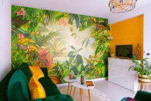 a living room with a tropical mural on the wall at Apartman GREEN in Brčko