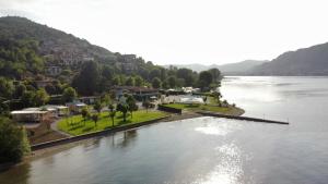 an aerial view of a river with houses and trees at Belvedere Clusane Camping in Iseo