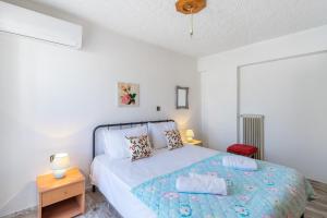 a bedroom with a bed and a red chair at Cozy apartment in Sitia