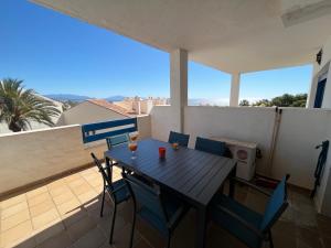 a table and chairs on the balcony of a house at Puerto de la Duquesa MINIMUM 3 NUITS in Manilva