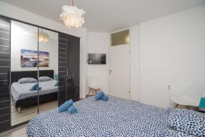 a bedroom with two beds and a mirror at Apartment Beta in Crikvenica