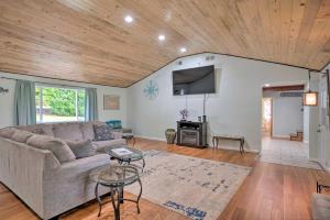 a living room with a couch and a wooden ceiling at Bungalow with Wraparound Deck - 8 Mi to Brookings in Smith River