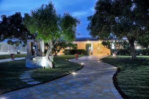 a walkway in front of a house at night at Tenuta Paifer in Otranto