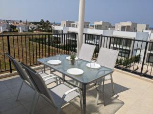 a blue table and chairs on a balcony at Adalena Court in Protaras