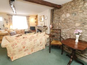 a living room with a couch and a table at Rose Cottage in Carnforth