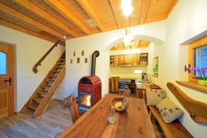 a living room with a wooden table and a wood stove at Granaries Pear & Walnut in Tolmin