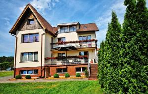 a large house with a balcony on top of it at BALTIC VIBES - pokoje gościnne in Kołobrzeg