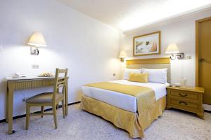 Postel nebo postele na pokoji v ubytování Hotel Olmeca Plaza