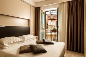 Postel nebo postele na pokoji v ubytování Hotel Smeraldo