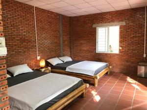 Postel nebo postele na pokoji v ubytování Nguyet Que Homestay & Tours