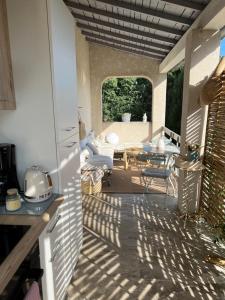 Blick auf eine Terrasse mit einem Tisch und einem Sofa in der Unterkunft Mas Coeur de Provence Calme Luxe Grand Parc in Pernes-les-Fontaines