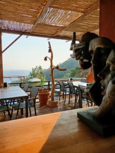 a restaurant with tables and chairs and a statue at Tree Houses Hotel in Fethiye