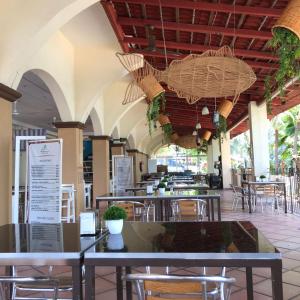 a restaurant with tables and chairs in a building at Acamar Beach Resort in Acapulco