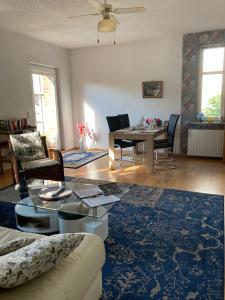 a living room with a table and a dining room at Villa Irene am Inselsee in Mühl Rosin