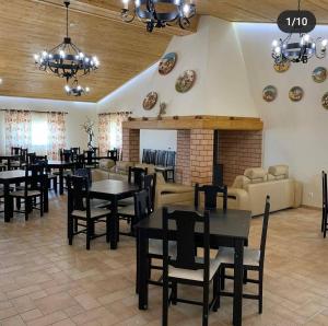a restaurant with tables and chairs and a fireplace at Herdade Monte Gordo in Ourique