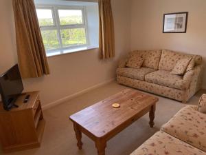 a living room with a couch and a coffee table at Church House Farm in Danby