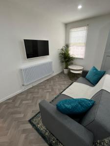 a living room with a couch and a flat screen tv at Warwick Town Centre Property in Warwick