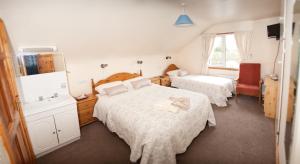 Кровать или кровати в номере Tower Lodge B&B
