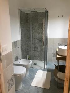 a bathroom with a shower and a toilet and a sink at L’alcova del centro in Pantelleria