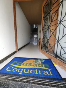 a blue rug on the floor in front of a staircase at Pousada Coqueiral in Aracruz