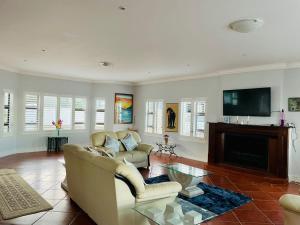 a living room with a couch and a fireplace at Ocean Pearl Holiday Home in Port Alfred