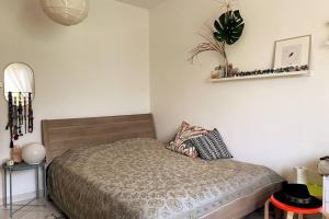 a bedroom with a bed and a plant on the wall at Garden of Eden in Dubai