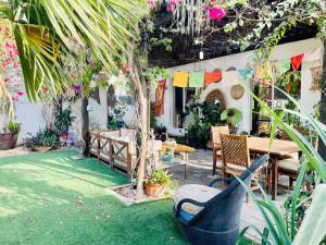 a patio with a table and chairs and plants at Garden of Eden in Dubai