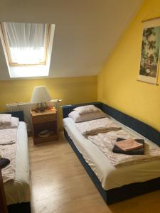 - une chambre avec deux lits et une table avec une lampe dans l'établissement Mary Apartment, à Siófok