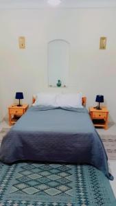 Un pat sau paturi într-o cameră la Residence Tozeur Almadina