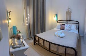 a bedroom with a bed with two towels on it at Nikos & Joanna's appartments in Makry Gialos +44 photos