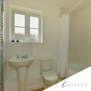 a white bathroom with a toilet and a sink at K Suites - Teeswater - FREE PARKING in Bridgwater