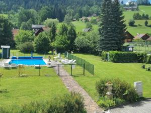 a backyard with a swimming pool in a yard at Apartment Seebachhof in Edlbach