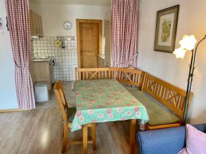 a kitchen with a table and a dining room at Ferienwohnung Am Untermarkt in Mittenwald +4 photos