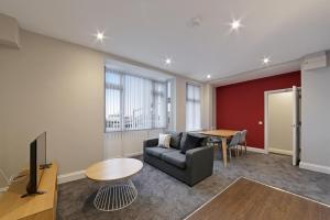 a living room with a couch and a table at K Suites - Waveney Chambers 1 in Lowestoft