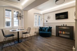 a living room with a couch and a table and chairs at Strict city apartments in Ljubljana