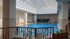 a large swimming pool with people in it at Temi's Apartments 2 in Skopje