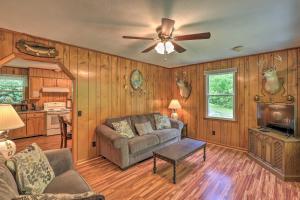 a living room with a couch and a ceiling fan at Secluded Marshall Cabin Near Appalachian Trail in Marshall