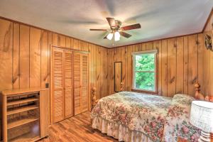 a bedroom with a bed and a ceiling fan at Secluded Marshall Cabin Near Appalachian Trail in Marshall