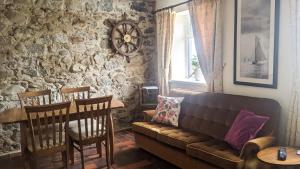 a living room with a couch and a table at Lough Shore Cottage in Magherafelt