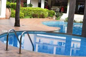 a swimming pool in a hotel with blue water at Premium 2 BHK Green Suites in Arpora