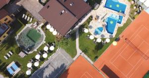 an overhead view of a house with a swimming pool at Vital & Sporthotel Brixen in Brixen im Thale